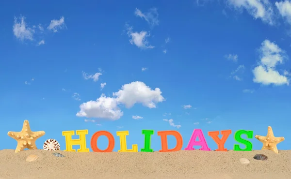 Holidays letters on a beach sand — Stock Photo, Image