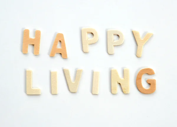Mensaje de Vida Feliz. Alfabetos de madera sobre fondo blanco . — Foto de Stock