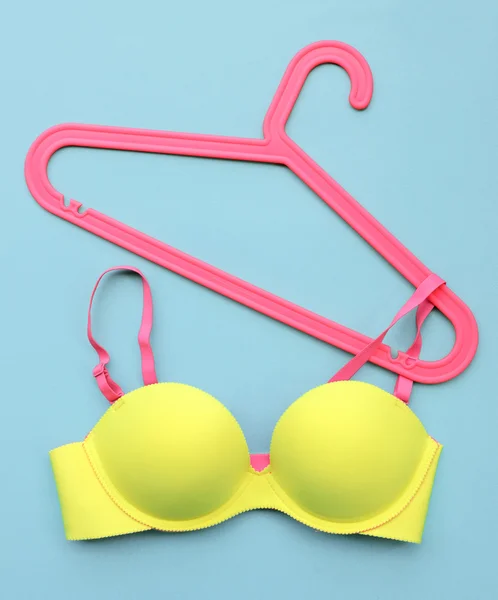 Summer concept, bra on coat hanger on blue. (Pop art style) — Stock Photo, Image