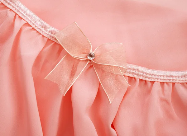 Arco rosa en vestido de tela rosa para el fondo — Foto de Stock