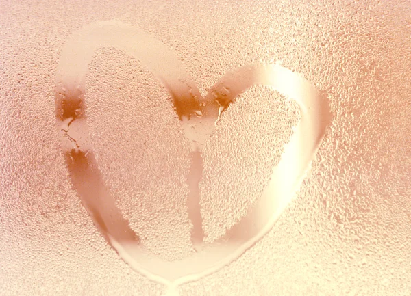 Rose gold color heart shape color, water drop on glass. Illuminate background. — Stock Photo, Image