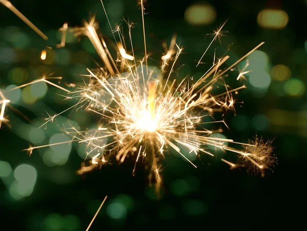 Holiday background with a sparkler — Stock Photo, Image