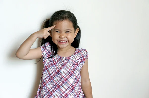 Little girl smiling and thinking — Stock Photo, Image