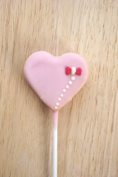 Pink strawberry candy on a stick in the form of heart — Stock Photo, Image