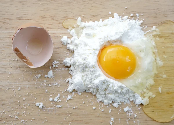 Белая мука и яйца на деревянном фоне — стоковое фото