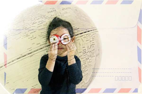 Double exposure of little girl looking through fruit as eyeglasses (travel concept) — Stock Photo, Image