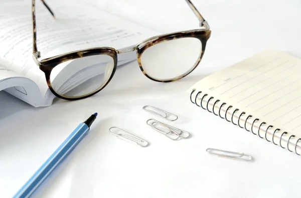 Ноутбук с очками и ручкой на столе, закрыть — стоковое фото