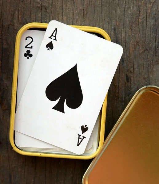 Ace of spades in box on wooden table background — Stock Photo, Image