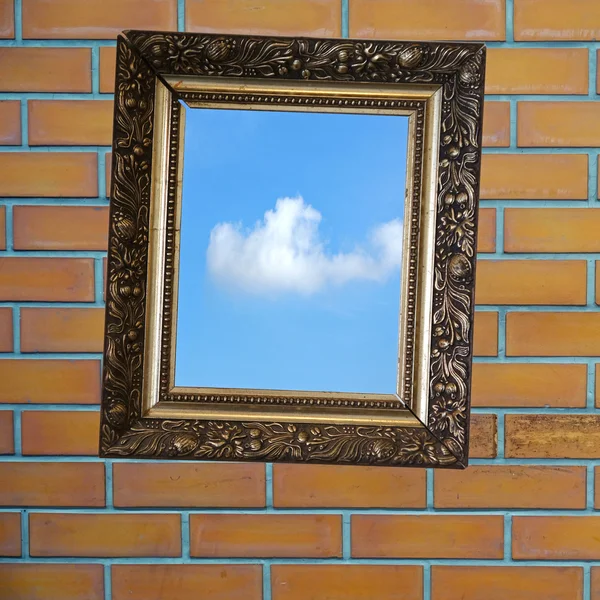 Golden frame on a dark brick wall. — Stock Photo, Image