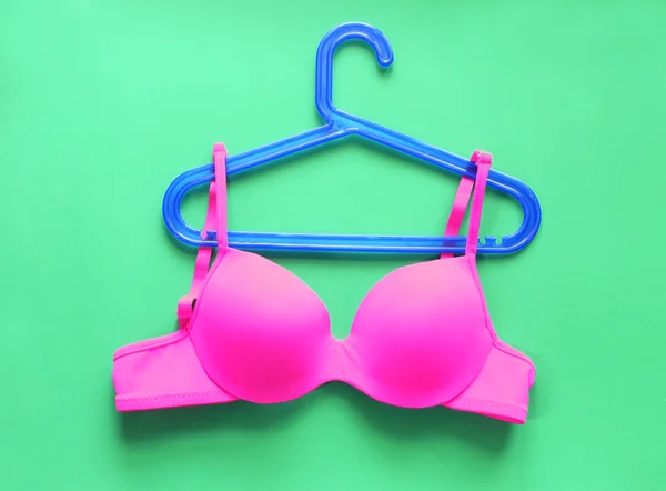 Summer concept, bra on coat hanger on green. (Pop art style) — Stock Photo, Image