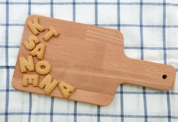 Lot of biscuits ABC on wooden plate — Stock Photo, Image