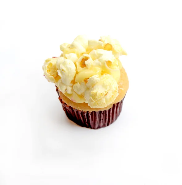 Cupcake with popcorn on white background — Stock Photo, Image