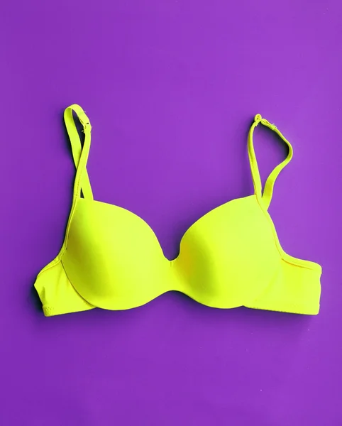 Yellow Cotton Bra on violet background — Stock Photo, Image