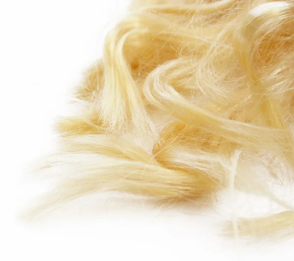 Blond vlasy na bílém pozadí — Stock fotografie