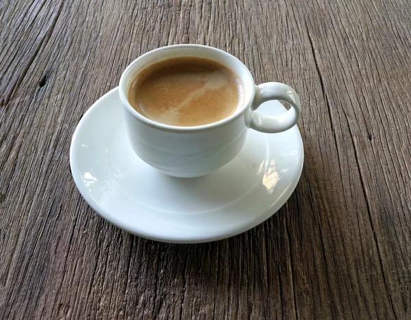 Cup of coffee on wooden background — Stock Photo, Image