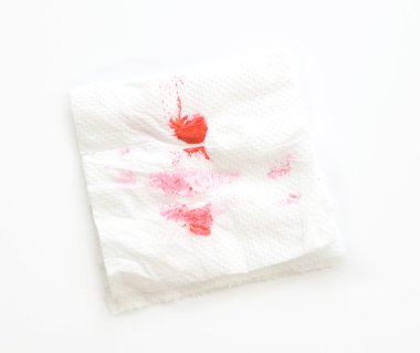 Lipstick mark on tissue paper on white