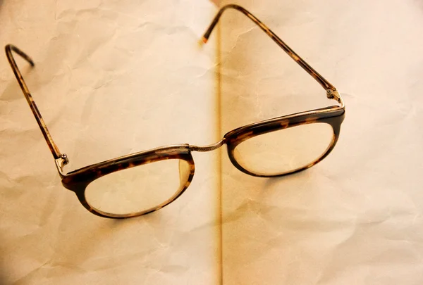 Old style eyeglasses on the vintage paper — Stockfoto