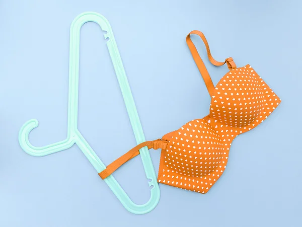 Summer concept, bra on coat hanger on blue. (Pop art style) — Stock Photo, Image