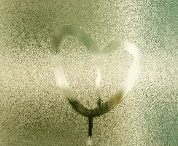 Heart painted on glass with rain drops — Stock Photo, Image