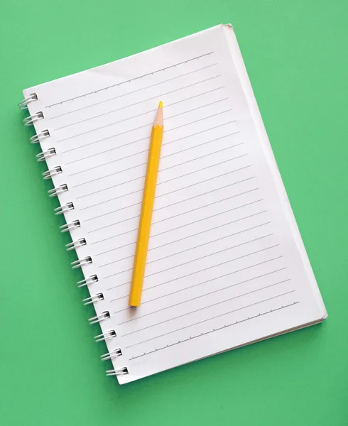 Top view of blank ring binder notebook and yellow wood pencil — Stock Photo, Image