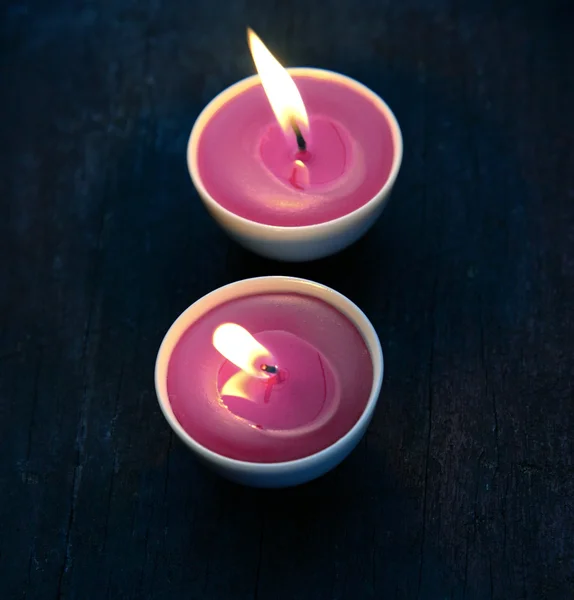 Burning candles in white small glass — Stock Photo, Image