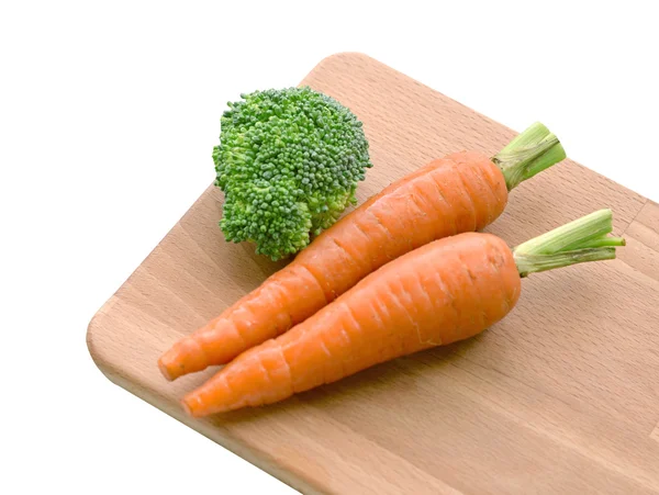 Fresh carrots and brocoli on wooden plate — Stock Photo, Image