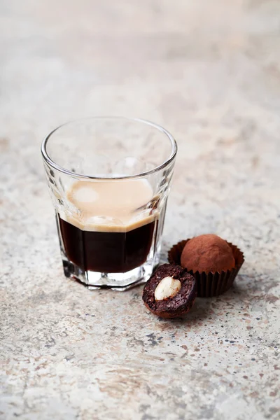 Chocolade noten truffels en glas espresso — Stockfoto