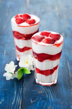 Dessert with strawberry sauce in glass clipart