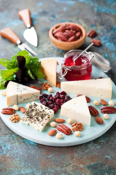 Various Types Cheese Wooden Plate Jam Nuts Dried Cranberries Selective Royalty Free Stock Images