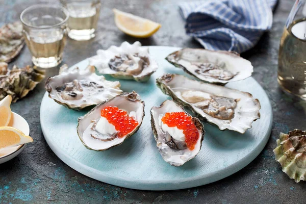 Fresh Oysters Garnished Red Caviar Sour Cream Served Blue Wooden Royalty Free Stock Images