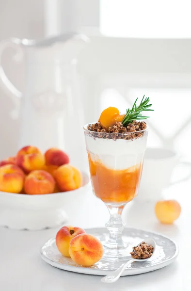 Yogurt with granola and apricots — Stock Photo, Image