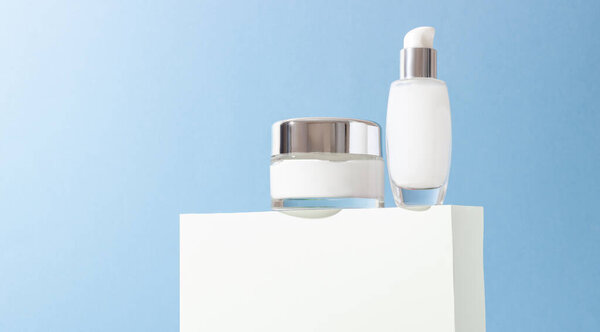 Косметические стеклянные бутылки со сливками и маской на взлетно-посадочной полосе с твердыми тенями. Концепция салона красоты и натуральной косметики.