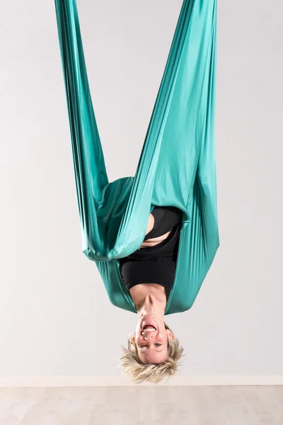 Laughing upside down woman doing aerial yoga — Stock Photo, Image