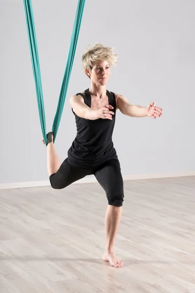 Woman doing aerial yoga workout for balancing — Stok fotoğraf