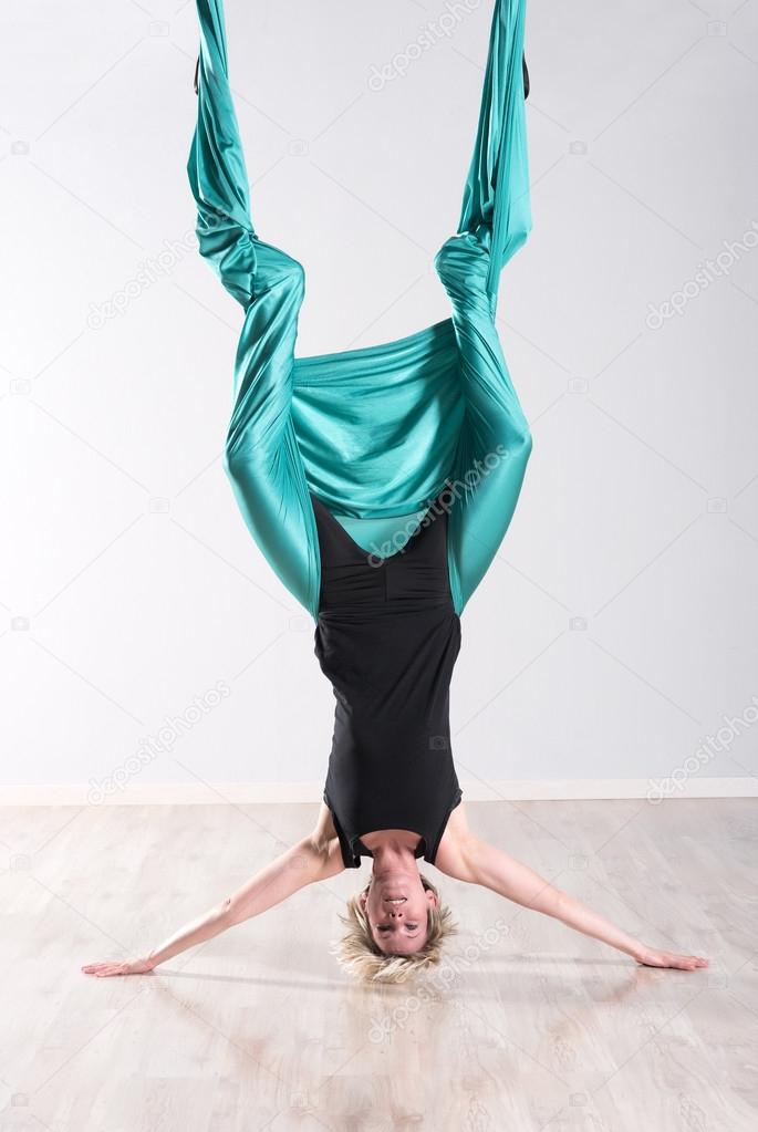 Woman Doing Aerial Yoga Upside Down On Head Stock Photo