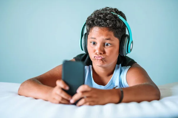 Charismatic Young Boy Pulling Quirky Face While Listening Music Stereo — Stock Photo, Image
