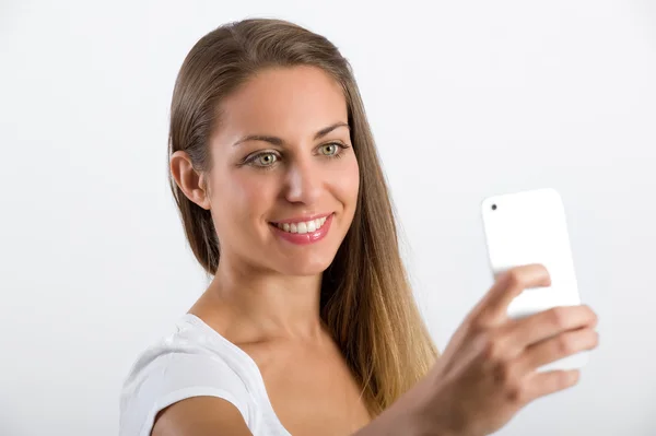 Mujer joven atractiva mirando su teléfono móvil — Foto de Stock