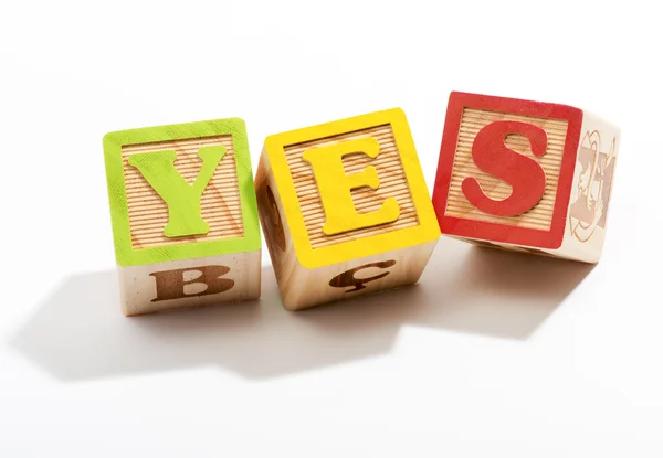 Yes in Wooden Letter Blocks on White Background — Stock Photo, Image