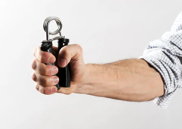 Male Hand Exercising Strength Using Hand Gripper — Stock Photo, Image