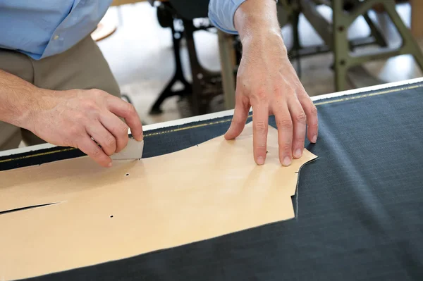 Clothing designer or tailor marking a pattern — Stock Photo, Image