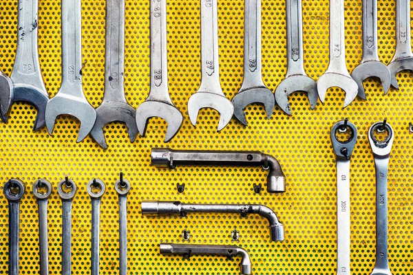 Agencement soigné des outils sur pegboard jaune — Photo