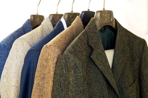 Assorted mens jackets on hangers — Stock Photo, Image