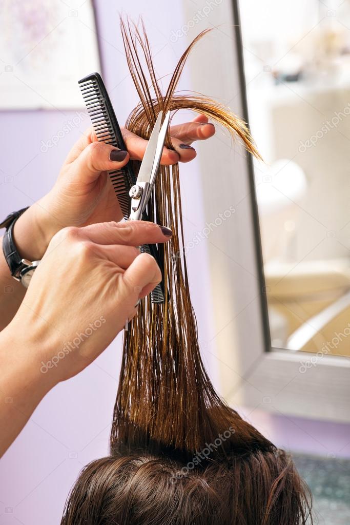 Hairdresser styling long brown hair