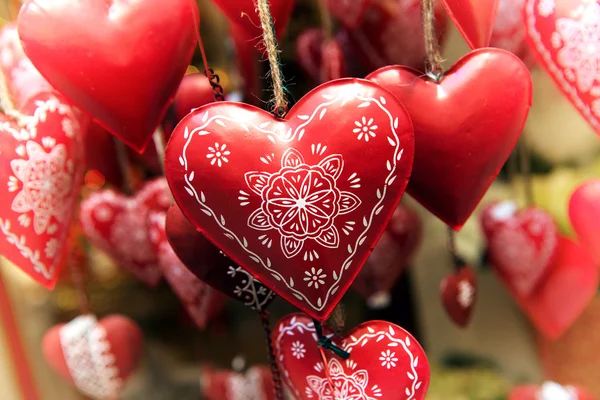 Hanging red decorated metal hearts — Stock Photo, Image