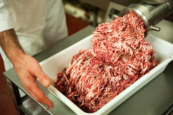 Tray full of minced meat next to machine — Stock Photo, Image