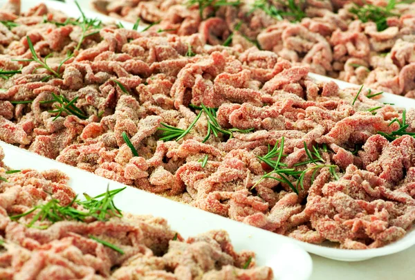 Trays of breaded strips of raw beef — Stock Photo, Image