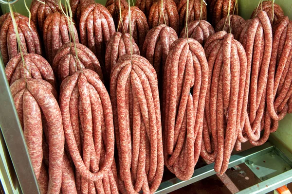 Saucisses assorties suspendues dans une boucherie — Photo