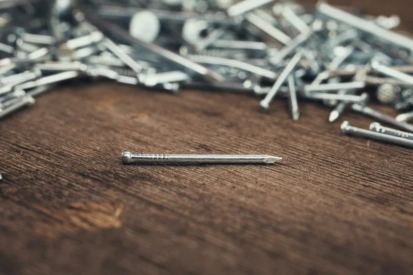 Iron nails on wooden background — Stock Photo, Image