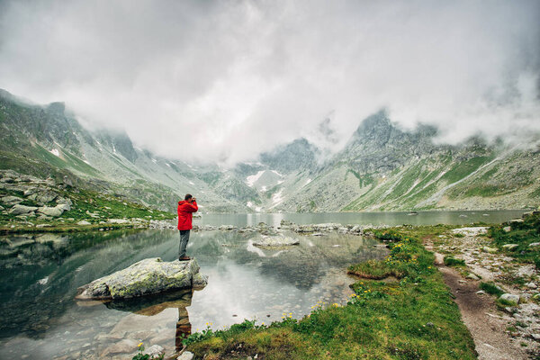 Man traveler near Lake Hincovo Pleso in High Tatras. The amazing nature of the High Tatra Mountains in Slovakia.