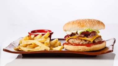 Burger. Juicy pork cutlet, cheddar cheese, crispy pickled onions, lettuce wrapped in a bun under two sauces. Served with french fries and cream sauce.